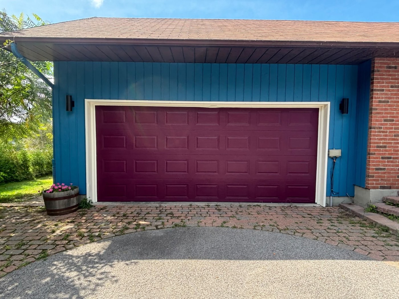 Freshly painted blue exterior siding with magenta garage door